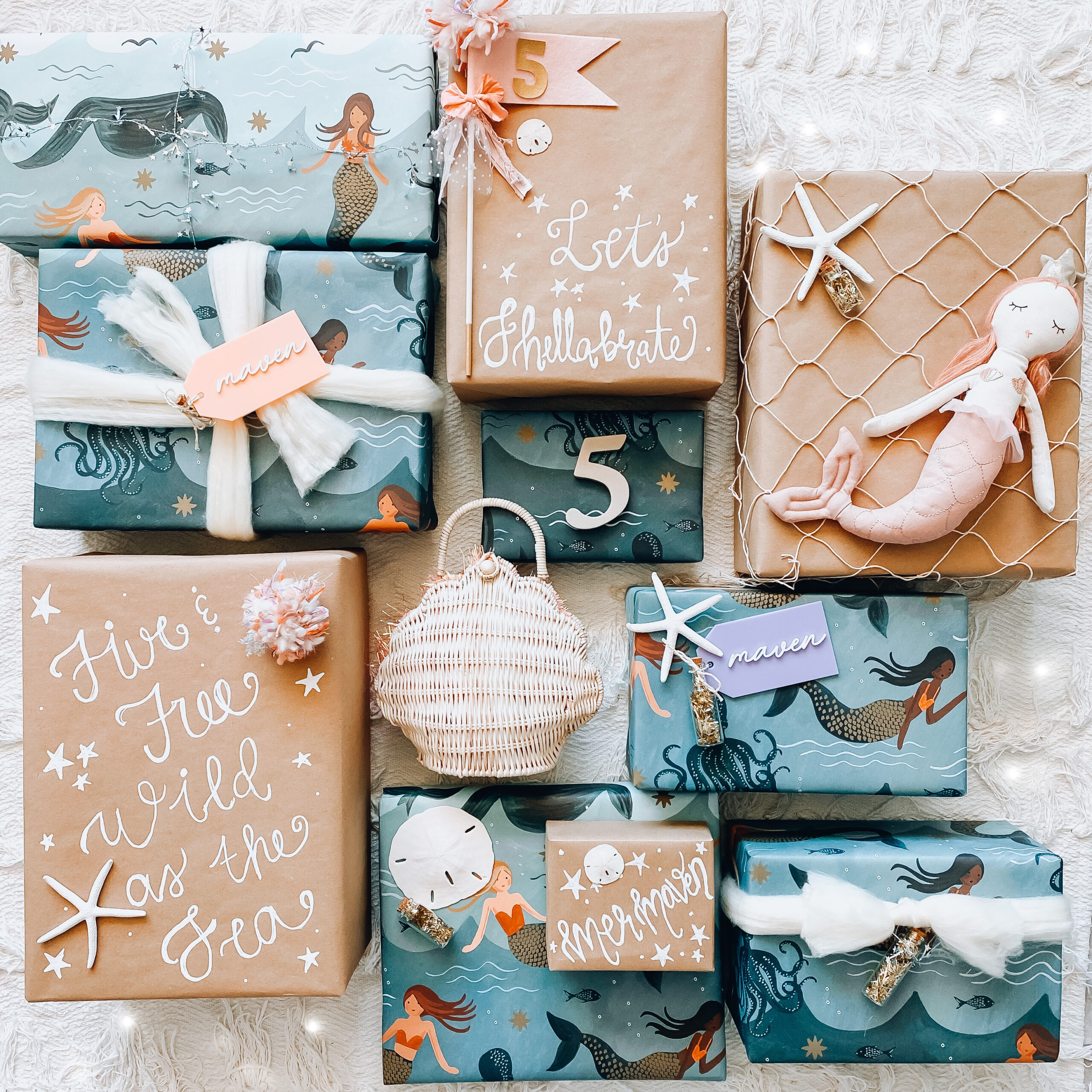 Green and blue gift wrap with mermaids on it fish net and seashell purse.